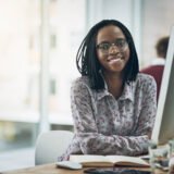Shot of a young businesswoman using a computer at her desk in a modern office